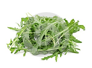 Heap of rocket salad leaves on white background.