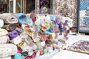 Heap of rolled up rugs in rug store