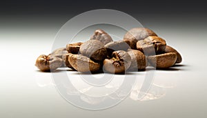 a heap of rosted coffee beans on a white background