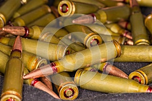 Heap of service rifle cartridges close-up in selective focus