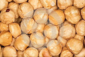 Heap of shelled hazelnuts, top view close-up