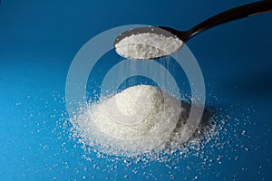 Heap of sugar and a spoon