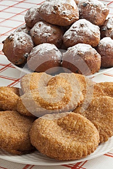 Heap of sugared fried fritters called oliebollen and appelflapp