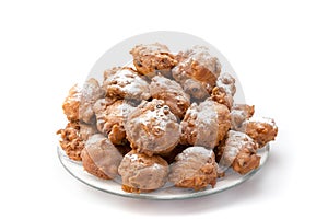 Heap of sugared fried fritters or oliebollen on scale