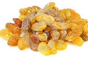 Heap of sun-dried jumbo golden raisins on white plate  closed-up