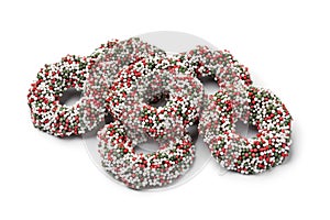 Heap of traditional Dutch Chocolate Christmas rings stuffed with fondant and covered with colorful sprinkles