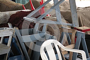 Heap of trestles or saddles, fishingnets and chairs near the coast of El Morche