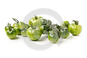 Heap of unripe green tomatoes over white background