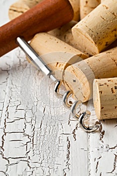 Heap of unused, new, brown natural wine corks with corkscrew on