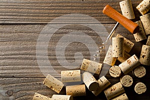 Heap of unused, new, brown natural wine corks with corkscrew on