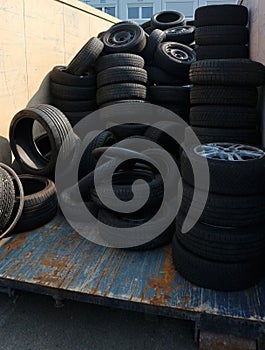Heap of used tires inside a container