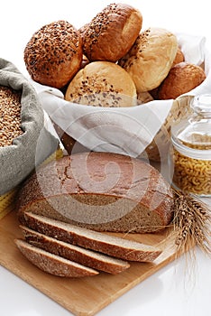 Heap of various bread, bag with wheat and macaroni