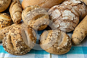 Heap of various bread rolls sprinkled with salt, caraway