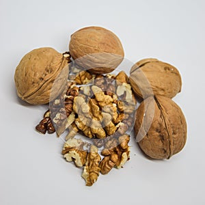 Heap of walnuts on white. cracked walnut isolated on the white background.