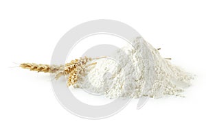 Heap of wheat flour with spikelets isolated on white