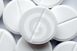 Heap of white round pills, close-up