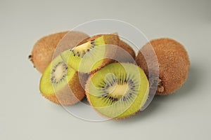 Heap of whole and cut fresh kiwis on white background, closeup