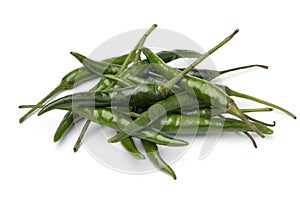 Heap of whole fresh raw green rawit peppers close up on white background