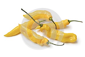 Heap of whole fresh raw ripe yellow Madame Jeanette peppers close up on white background