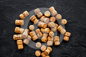 Heap of wine bottle corks on black background top view