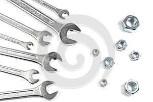 Heap Of Wrenches Of Different Sizes Against Nuts Of Different Sizes Isolated On White