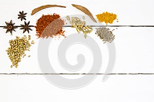 Heaped spices on white table