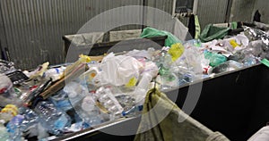 Heaps of miscellaneous unsorted waste in containers, plastic, cellophane, paper.