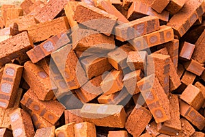 Heaps of red clay bricks at construction site