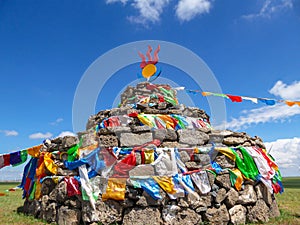 Heaps of stones (Aobao) build on a vast pasture in Xilinhot in Inner Mongolia. The Heaps has a lot of colorful prayer flags