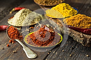 Heaps of various ground spices on wooden background. Georgian spices, Indian spices, Arabian spices. Spice variety. Herbs and spic photo