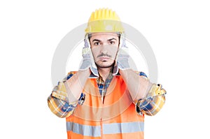 Hear no evil gesture with handsome engineer or constructor