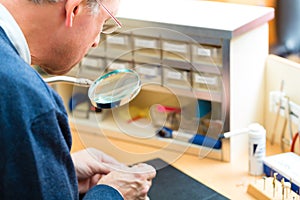 Acoustician working on a hearing aid photo