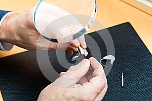 Acoustician working on a hearing aid photo