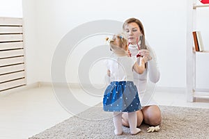 Hearing aid in baby girl`s ear. Toddler child wearing a hearing aid at home. Disabled child, disability and deafness