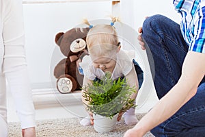 Hearing aid in baby girl`s ear. Toddler child wearing a hearing aid at home. Disabled child, disability and deafness