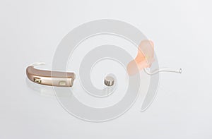Hearing aid, earmold and a battery