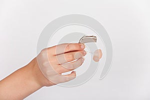 Hearing aid in a hand