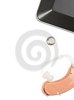 Hearing aid next to a box on a white isolated background