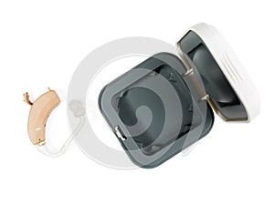 Hearing aid next to the open box from the apparatus on a white isolated background