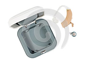 Hearing aid next to the open box. Top view on white isolated background