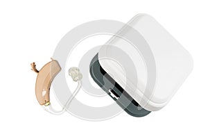 Hearing aid next to a white box on a white isolated background