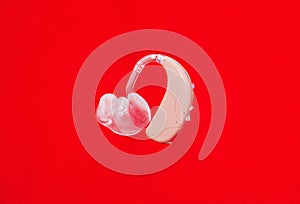 Hearing aid on red