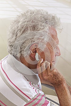 Hearing aid on senior man