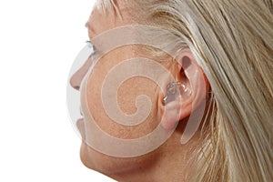 Hearing aid in woman`s ear