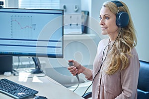 Blonde long-haired woman having a hearing check at the hospital