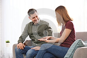 Hearing impaired friends using sign language for communication on sofa