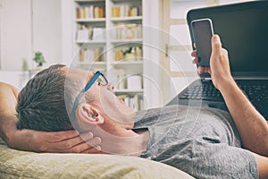 Hearing impaired man with laptop and mobile phone