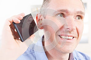 Hearing impaired man using mobile phone