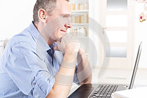 Hearing impaired man working with laptop