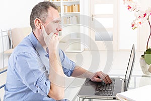 Hearing impaired man working with laptop